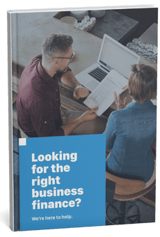 Showing two professionals reviewing a business finance guide on a laptop.